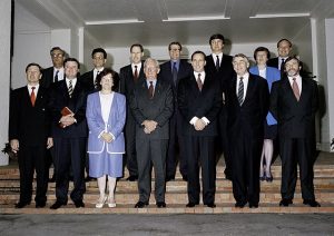 12 men and 2 women standing on the steps of a building